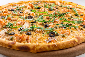 Delicious Shrimp Pizza with Arugula and Olives on Wooden Board