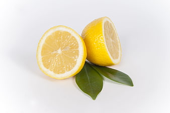 Fresh Sliced Lemon with Green Leaves on White Background