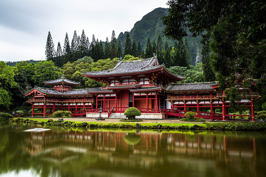 Traditional Japanese Temple by Lake with Mountain Reflection