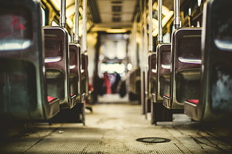 Empty subway car interior with metal seats and blurred passengers