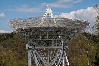 Large White Radio Telescope Dish in Forest