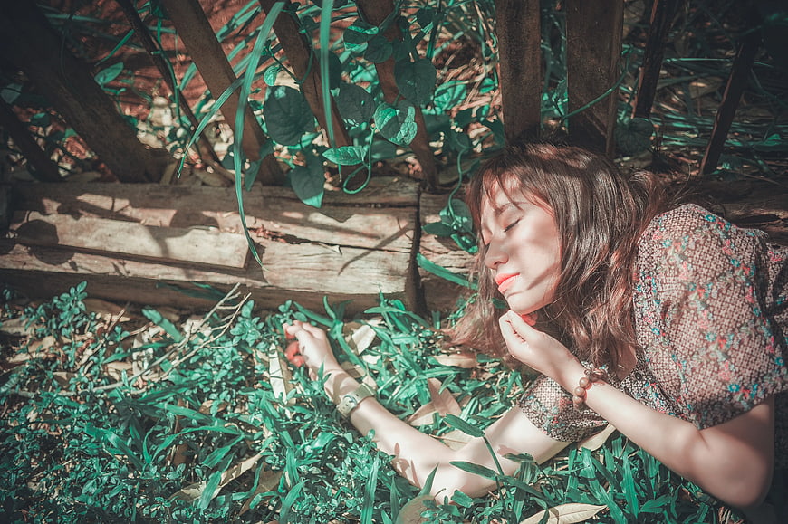 Woman Sleeping Peacefully in Garden Grass