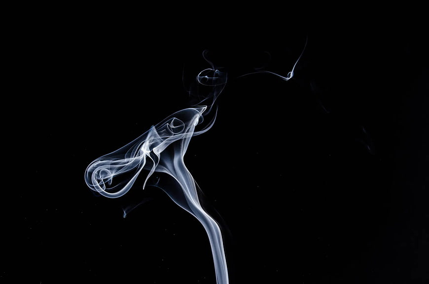 Abstract White Smoke Swirls on Black Background