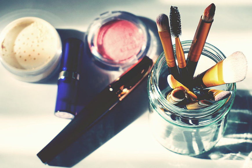 Makeup Brushes and Cosmetics in Glass Jar