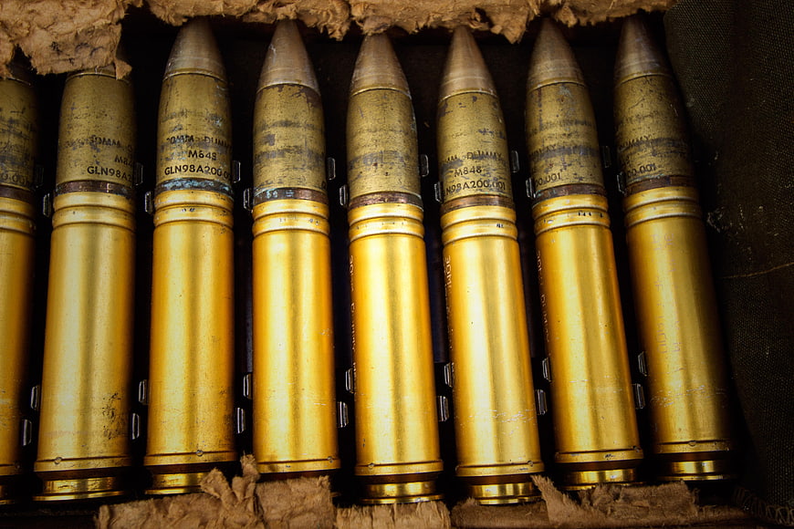 Close-up of brass rifle ammunition cartridges in a box