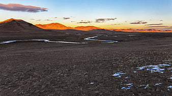 Mongolian Steppe Landscape With Frozen River And Sunset Mountains