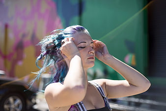 Woman with Blue Hair Closing Eyes in Sunlight