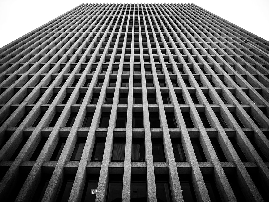 Low angle black and white skyscraper grid facade