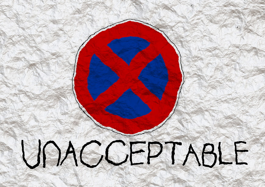 Hand-drawn no entry sign with unacceptable text on crumpled paper