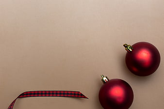 Minimal Christmas Ornaments and Ribbon on Beige Background