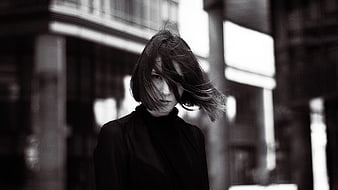 Black and white portrait of woman with windblown hair