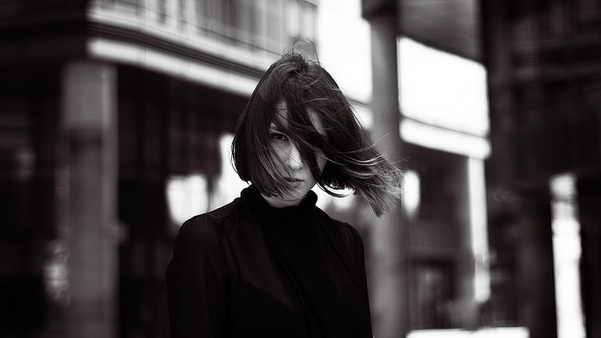 Black and white portrait of woman with windblown hair