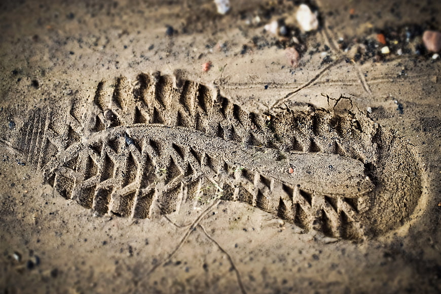 Close-up of detailed shoe tread print in dry sand