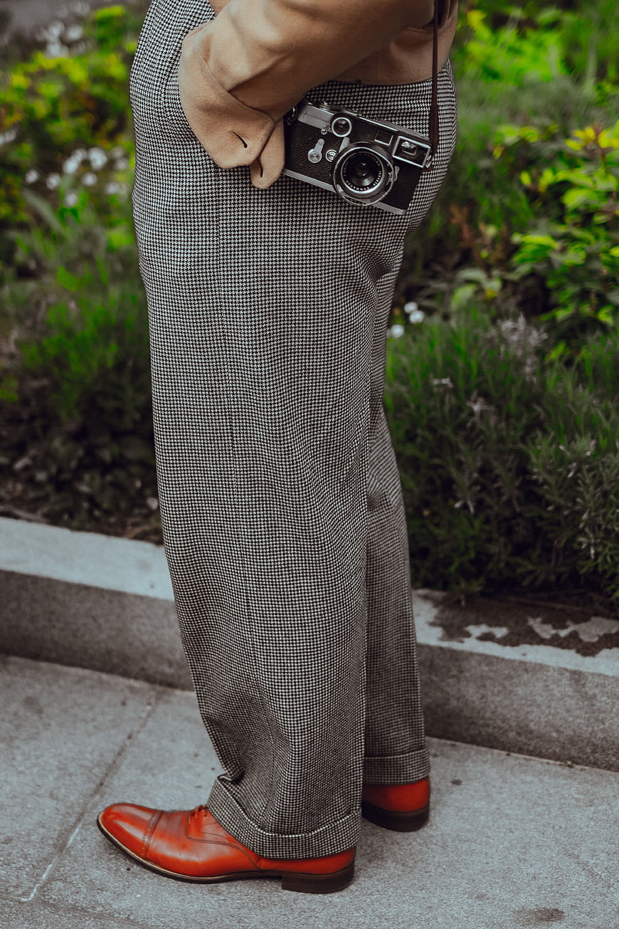 Man in Houndstooth Trousers with Vintage Camera and Red Shoes