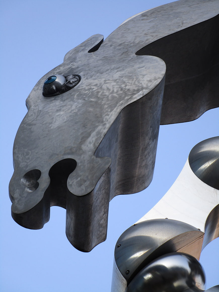 Metallic Horse Head Sculpture Against Blue Sky