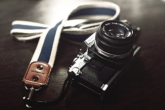 Vintage Olympus OM-10 Film Camera on Wooden Table