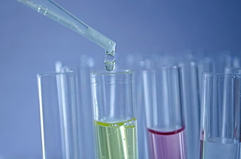 Pipette Dropping Liquid Into Test Tubes In Laboratory