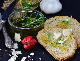 Mediterranean Bruschetta with Olive Oil, Garlic, and Rosemary on Dark Background