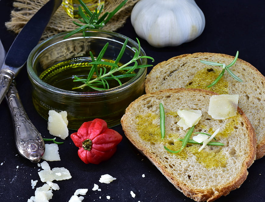 Mediterranean Bruschetta with Olive Oil, Garlic, and Rosemary on Dark Background