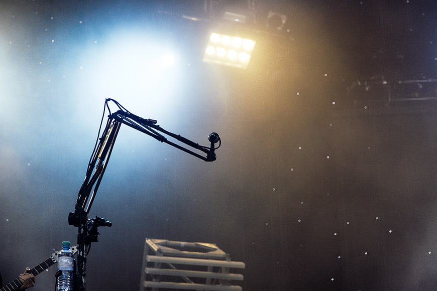 Microphone stand on concert stage with dramatic lighting