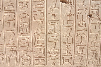 Ancient Egyptian Hieroglyphs Carved in Stone Wall