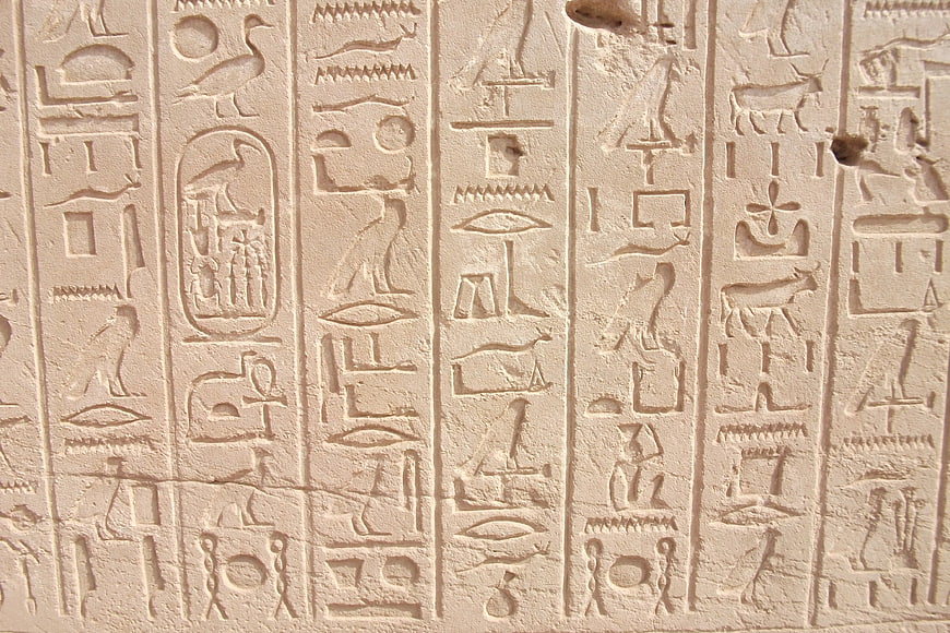 Ancient Egyptian Hieroglyphs Carved in Stone Wall