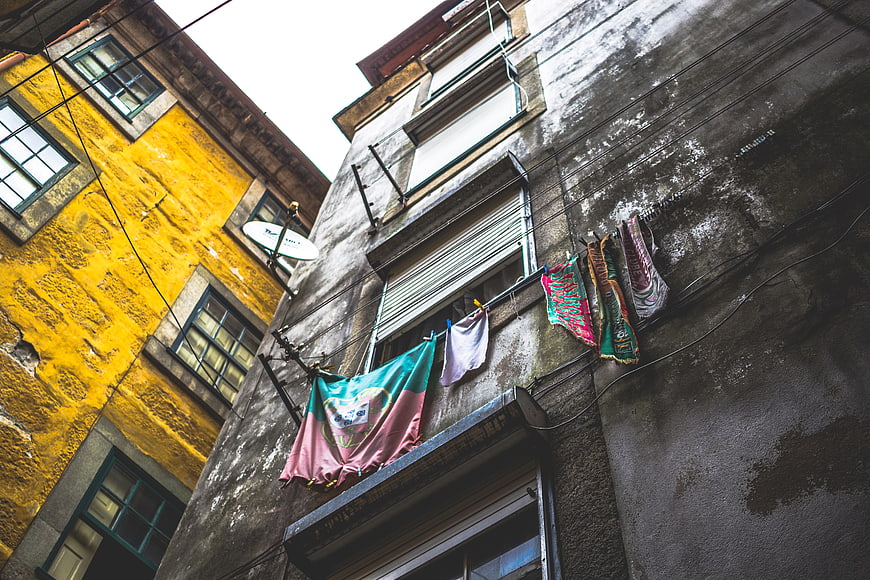 Low angle view of laundry hanging on old European building facade