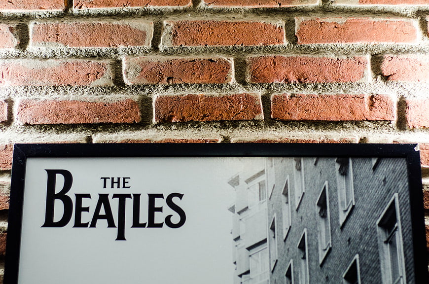 The Beatles framed poster on red brick wall