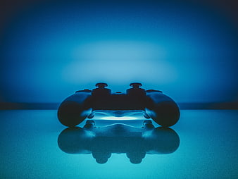 Silhouette of a video game controller on a reflective surface with blue neon lighting