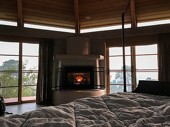 Cozy Bedroom Interior with Fireplace and Large Windows