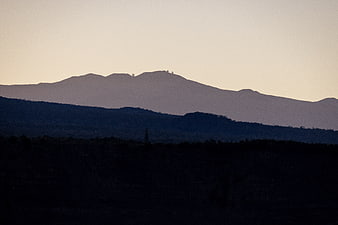 Silhouetted Mountain Range at Dusk with Observatory