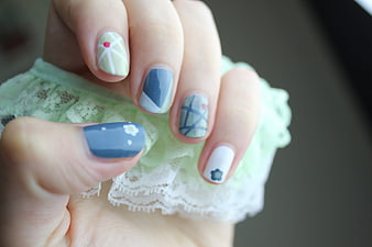 Close-up of pastel blue and green floral nail art design