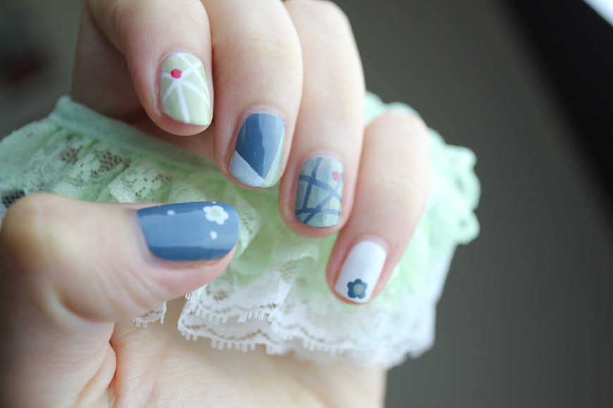 Close-up of pastel blue and green floral nail art design