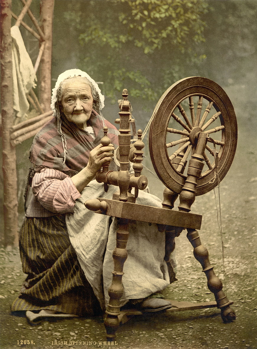 Historical Portrait of Elderly Woman Operating Traditional Irish Spinning Wheel