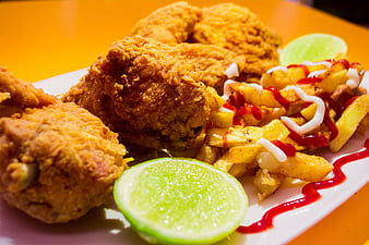 Crispy Fried Chicken and Fries with Lime and Ketchup on White Plate