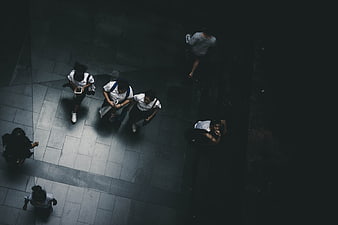 Aerial view of students walking on dark pavement