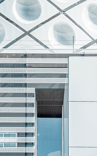 Modern White Geometric Architecture with Perforated Metal Facade