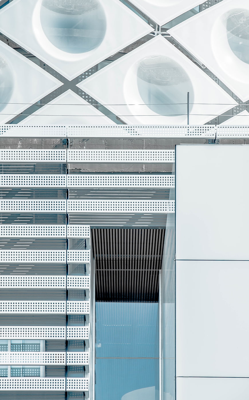 Modern White Geometric Architecture with Perforated Metal Facade