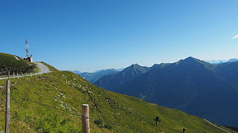 Scenic Alpine Mountain Landscape with Winding Road and Communication Tower