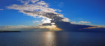 Panoramic Ocean Sunset with Dramatic Clouds and Sunbeams