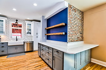 Modern kitchen with blue accent wall and exposed brick