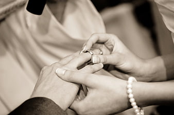 Close-up of wedding ring exchange ceremony hands