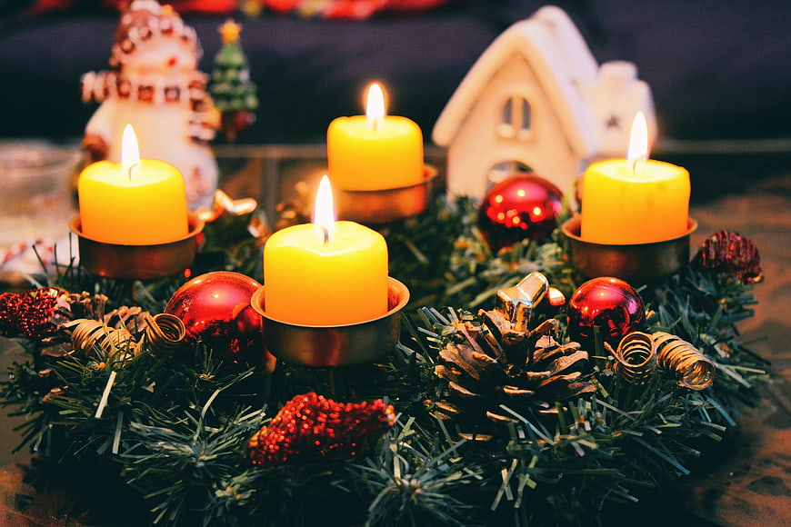 Advent Wreath with Four Lit Candles and Christmas Decorations