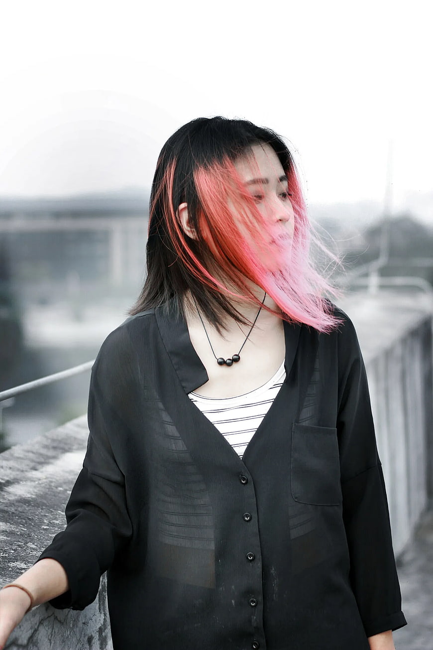 Woman with Pink Hair on Windy Rooftop