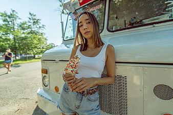 Stylish Woman Eating Sprinkle Ice Cream Cone by Food Truck