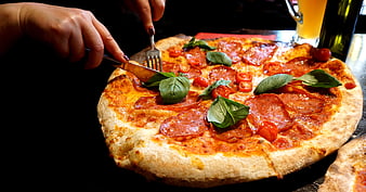 Fresh Margherita Pizza With Basil And Tomatoes Being Served