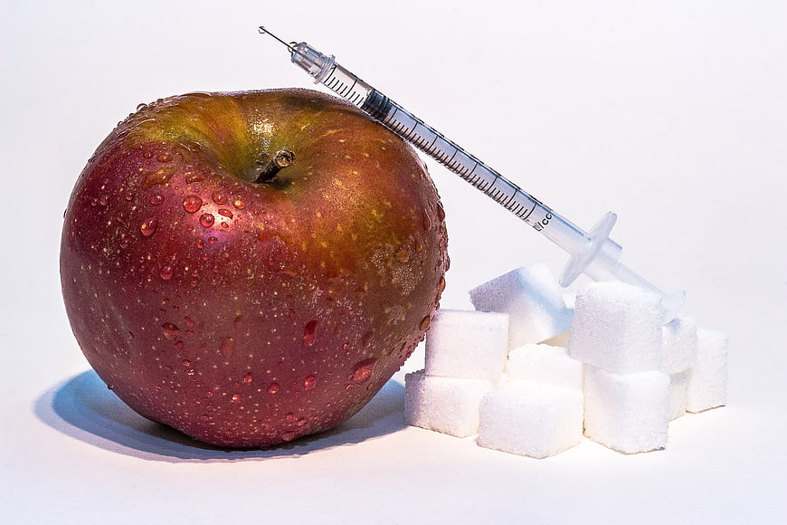 Red Apple with Insulin Syringe and Sugar Cubes
