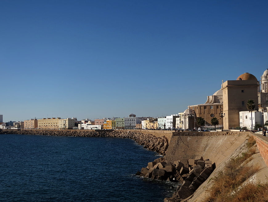 Sunny coastal cityscape with historic architecture and blue sea