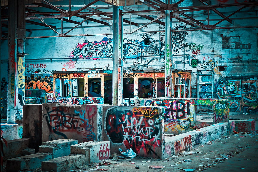 Abandoned industrial factory interior covered in colorful graffiti art