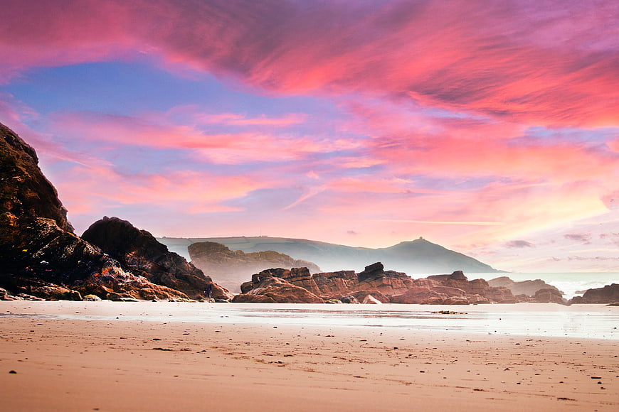 Dramatic Pink Sunset Over Rocky Beach and Ocean